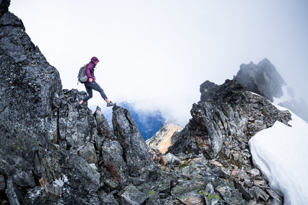Healthy happy woman hiking on a mountain ridge